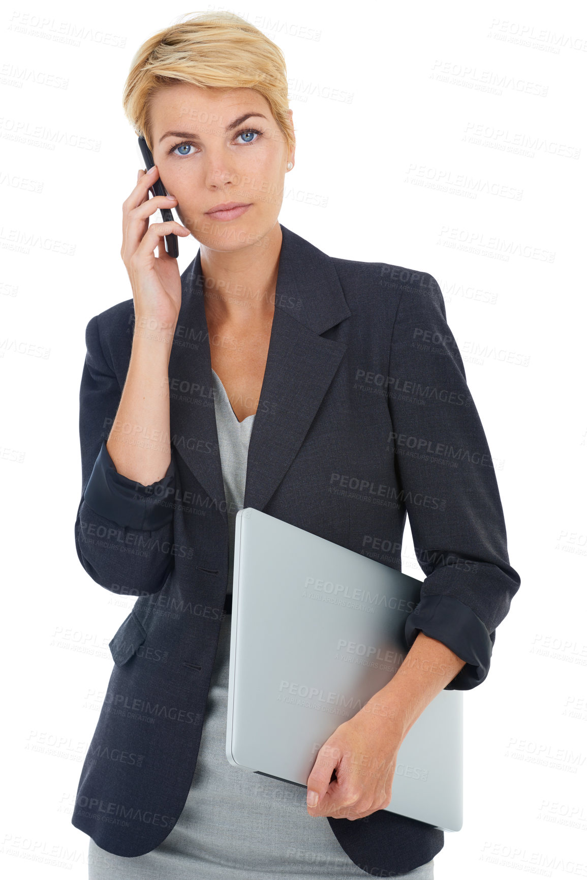 Buy stock photo A young businesswoman talking on her cellphone while carrying her laptop