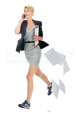 Buy stock photo A young businesswoman dropping her papers while talking on her cellphone