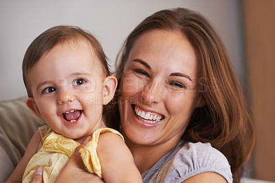 Buy stock photo Mother, baby and smile in embrace at home, love and together for bonding in childhood. Mommy, daughter and support for happy toddler in child development, mama and security or connection on sofa