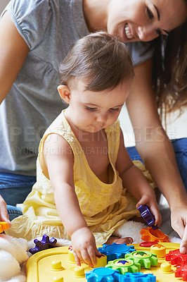 Buy stock photo Baby, mom and toys in living room floor, bonding together and sensory growth in family home. Motherhood, girl and play with child development for games, childhood or fun with love, cognition or kids

