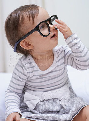 Buy stock photo Eye care, vision and young baby with glasses for eyesight, prescription lens frame or ocular support. Face accessory, pediatric ophthalmology and relax youth girl, infant or toddler with eyeglasses