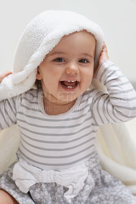 Buy stock photo Shot of a cute little baby girl sitting on the floor playing with her blanket