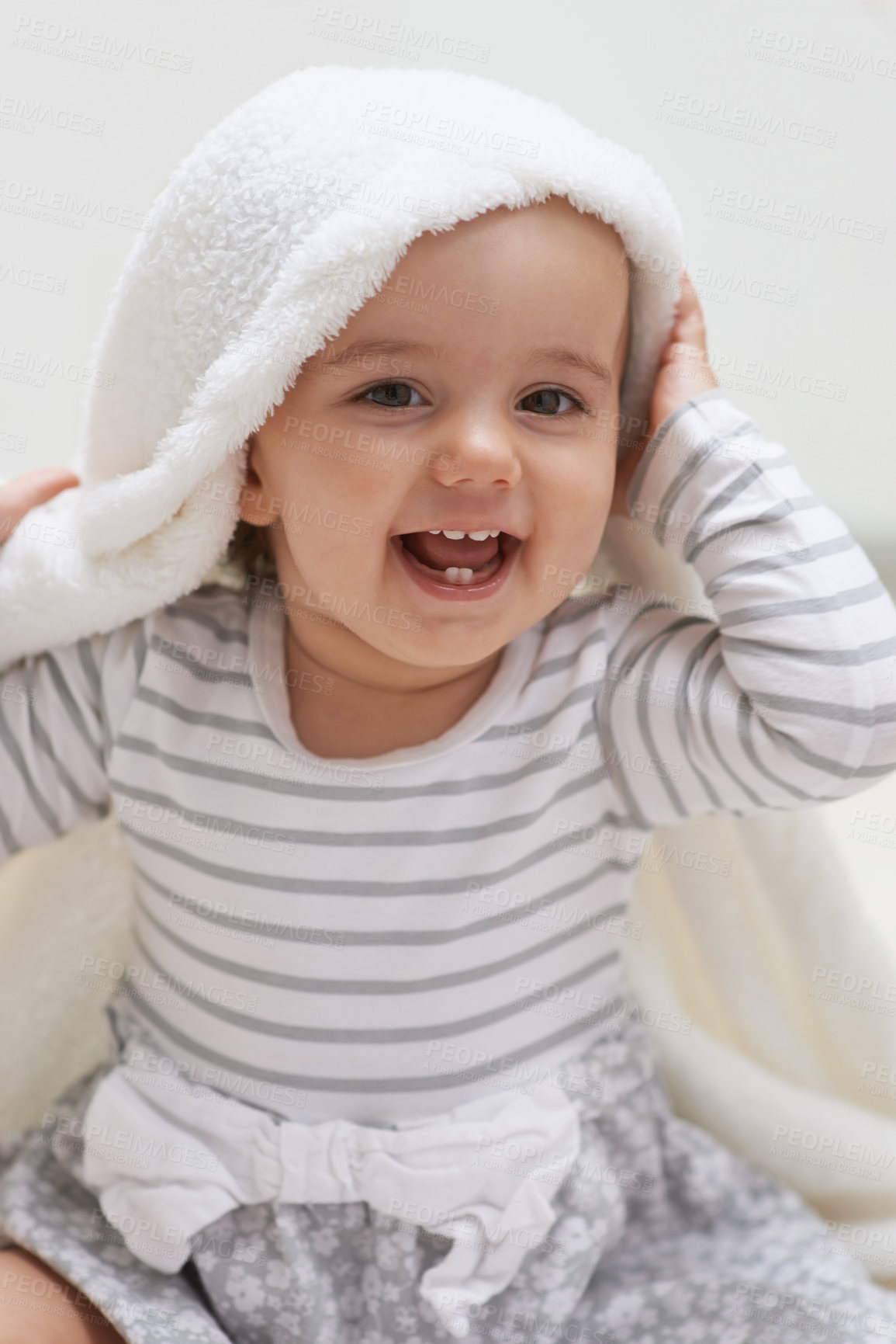 Buy stock photo Shot of a cute little baby girl sitting on the floor playing with her blanket