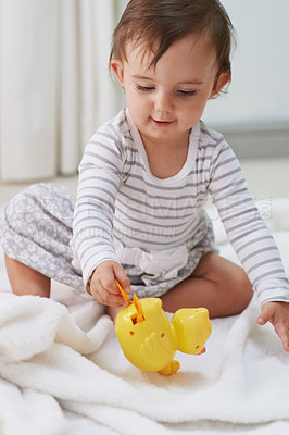 Buy stock photo Baby, playing and toys in living room floor, duck and sensory growth in family home. Curious, girl and play for child development, games and childhood memories or fun to learn, cognition or kids
