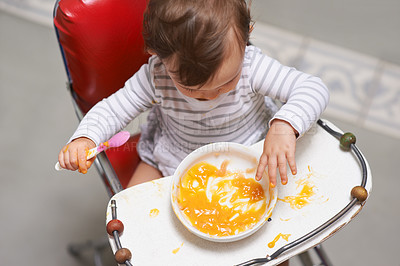 Buy stock photo Baby eating, high chair and food, nutrition and health for childhood development and wellness. Healthy, growth and toddler person at home, vegetable or fruit, hungry kid with lunch or dinner meal