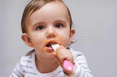 Buy stock photo Spoon, food and baby eating in a studio for organic, healthy or nutrition vegetable meal. Sweet, cute and girl kid or toddler enjoy dinner, breakfast or lunch for child development by gray background
