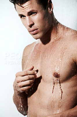 Buy stock photo Serious man in shower to relax, cleaning and body hygiene for morning skin wellness routine. Grooming, skincare and face of male model with muscle washing with water, self care and calm in bathroom.