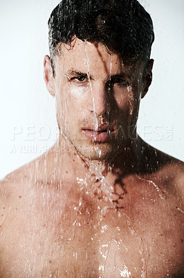 Buy stock photo Portrait of man in shower to relax, cleaning hair and body for morning wellness, hygiene or routine. Grooming, skincare and serious face of male model washing in water, self care and calm in bathroom