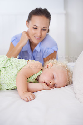 Buy stock photo Smile, sleeping and mother with baby on bed for bonding, relax and sweet cute relationship. Happy, love and young mom watching girl child, kid or toddler taking a nap in bedroom or nursery at home.