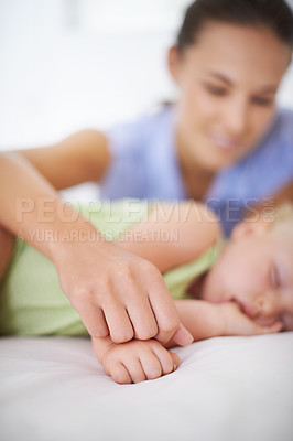 Buy stock photo Hands, sleeping and mother with baby on bed for bonding, relax and sweet cute relationship. Happy, smile and young mom watching girl child, kid or toddler taking a nap in bedroom or nursery at home.