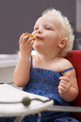 Buy stock photo Kid, high chair and eating cupcake, food and breakfast sweets at home in kitchen. Young child, hungry toddler and muffin dessert, sugar and pastry snack for cute adorable girl in house in the morning