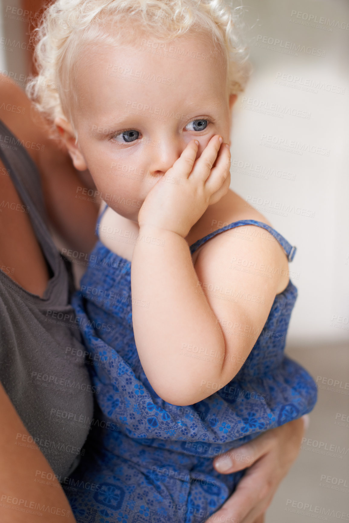 Buy stock photo A sweet little baby girl sitting in her mother's arms