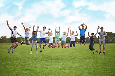 Buy stock photo A group of young people jumping in the air on a sportsfield