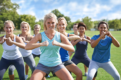 Buy stock photo Woman, fitness and class on green grass in nature for workout or exercise with outdoor coach. Female person or group of active athletes in team training for motivation or sports community on field