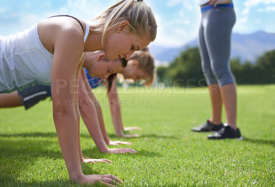 Buy stock photo Women, teamwork and push ups on grass for fitness with exercise, training and coach on sports field. Athlete, people and collaboration on ground with physical activity for healthy body and wellness
