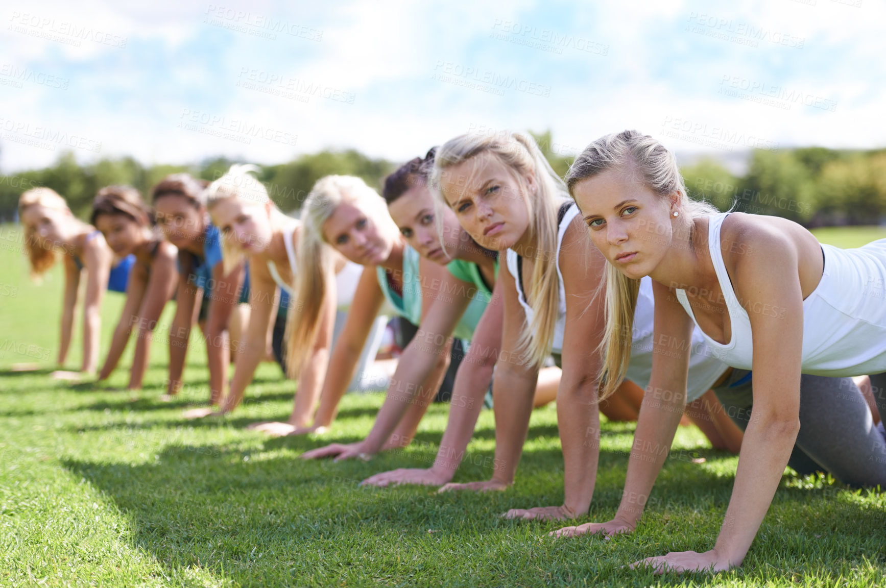 Buy stock photo Women, push up and exercise outdoor, team and ready for workout, health and wellness in portrait. Training together on sports field, young athlete group and fitness for muscle and strength in park