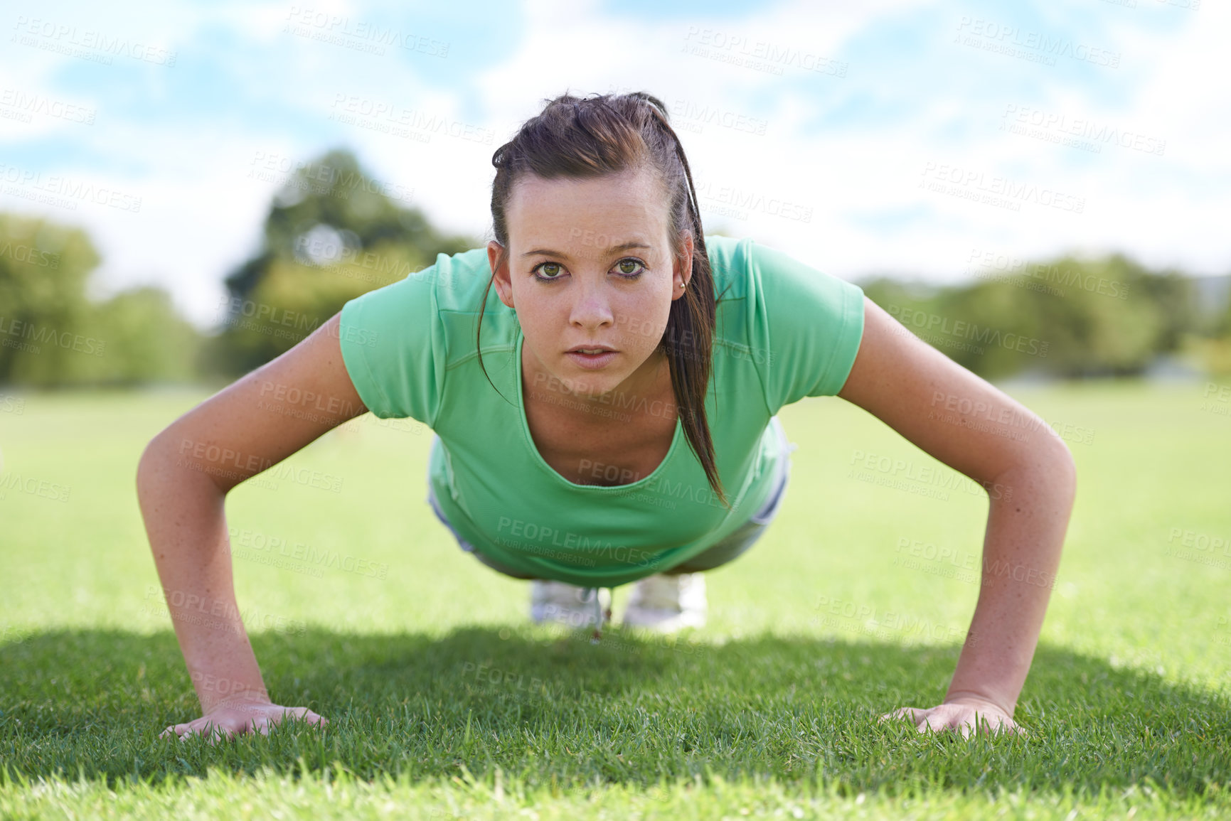 Buy stock photo Women, portrait and push ups on grass for training with exercise, fitness and workout on sports field. Athlete, person and confidence on ground with physical activity for healthy body and wellness