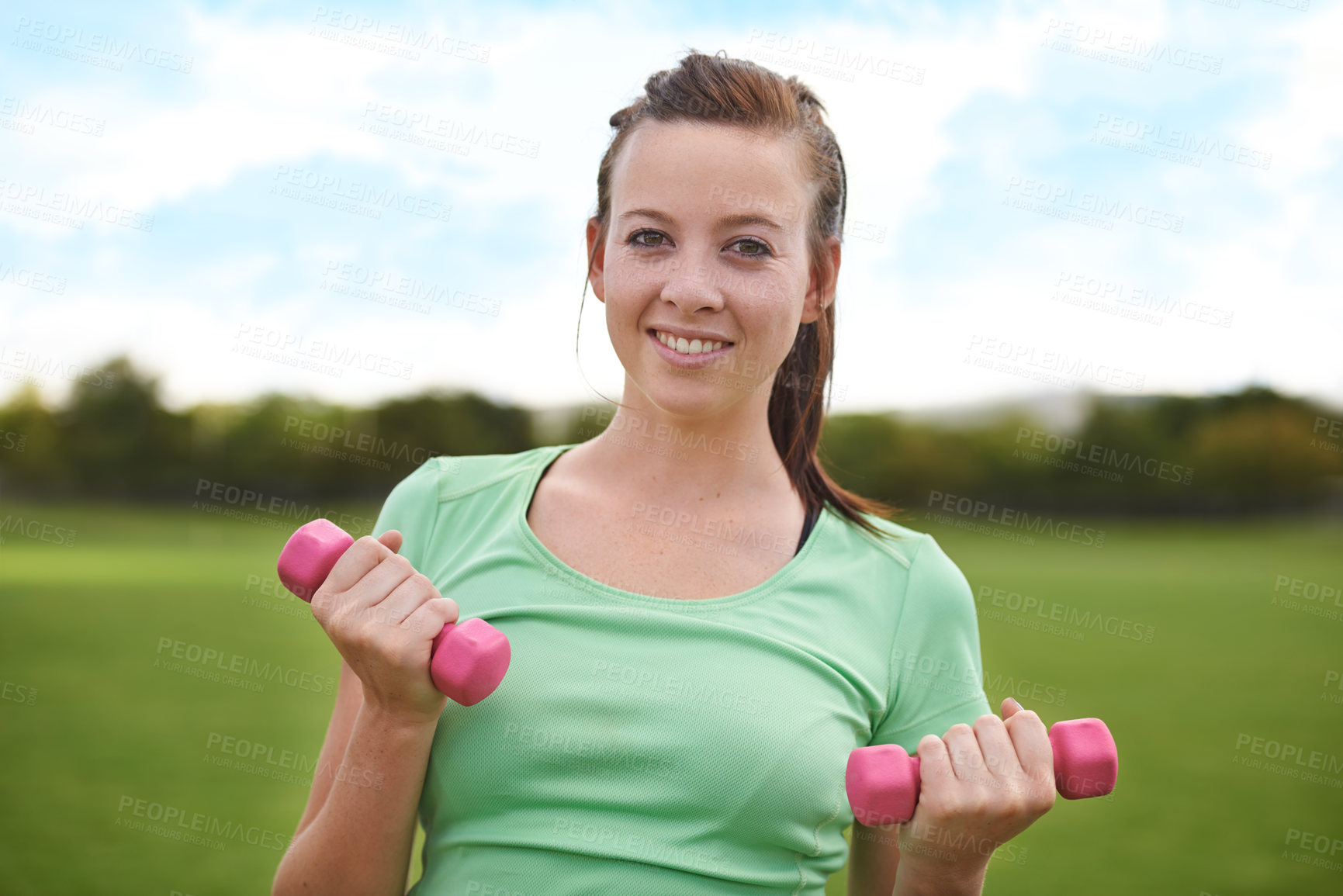 Buy stock photo Happy woman, portrait and dumbbells for weightlifting in fitness, workout or outdoor exercise in nature. Active female person or athlete smile for training, health and wellness on green grass field