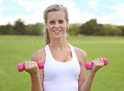 Buy stock photo Woman, portrait and dumbbells outdoor for fitness with smile for workout, training or exercise on sports field. Athlete, person and happy for physical activity or healthy body on grass with equipment