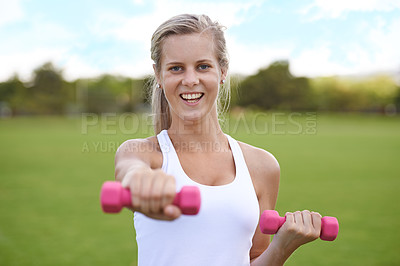 Buy stock photo Woman, portrait and dumbbell outdoor for wellness with smile for workout, training or fitness on sports field. Athlete, person and happy for physical activity or healthy body on grass with equipment