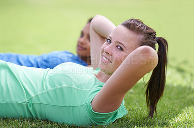 Buy stock photo Happy woman, portrait and sit ups for fitness, workout or outdoor exercise together on green grass. Young active female person or people smile for core strength, training and lying on field in nature