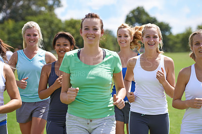 Buy stock photo Women, fitness in group and running in park for cardio, health and wellness with training together for race. Marathon, workout and energy on sports field, runner team with smile and exercise outdoor