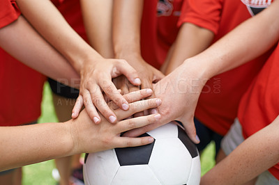 Buy stock photo Cropped image of a group of girls with their hands piled on top of a soccer ball