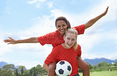 Buy stock photo Happy woman, friends and piggyback for outdoor soccer on green grass in winning, achievement or sport in nature. Portrait of female person or football player smile for match, game or victory on field
