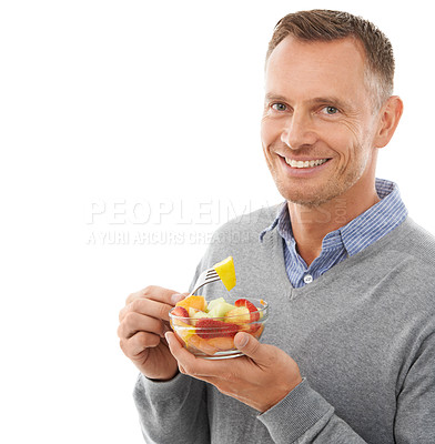 Buy stock photo Portrait, studio and happy man eating fruit salad for healthy snack, diet meal or craving. Happiness, smile and male model enjoying fresh produce for health and wellness isolated by white background.