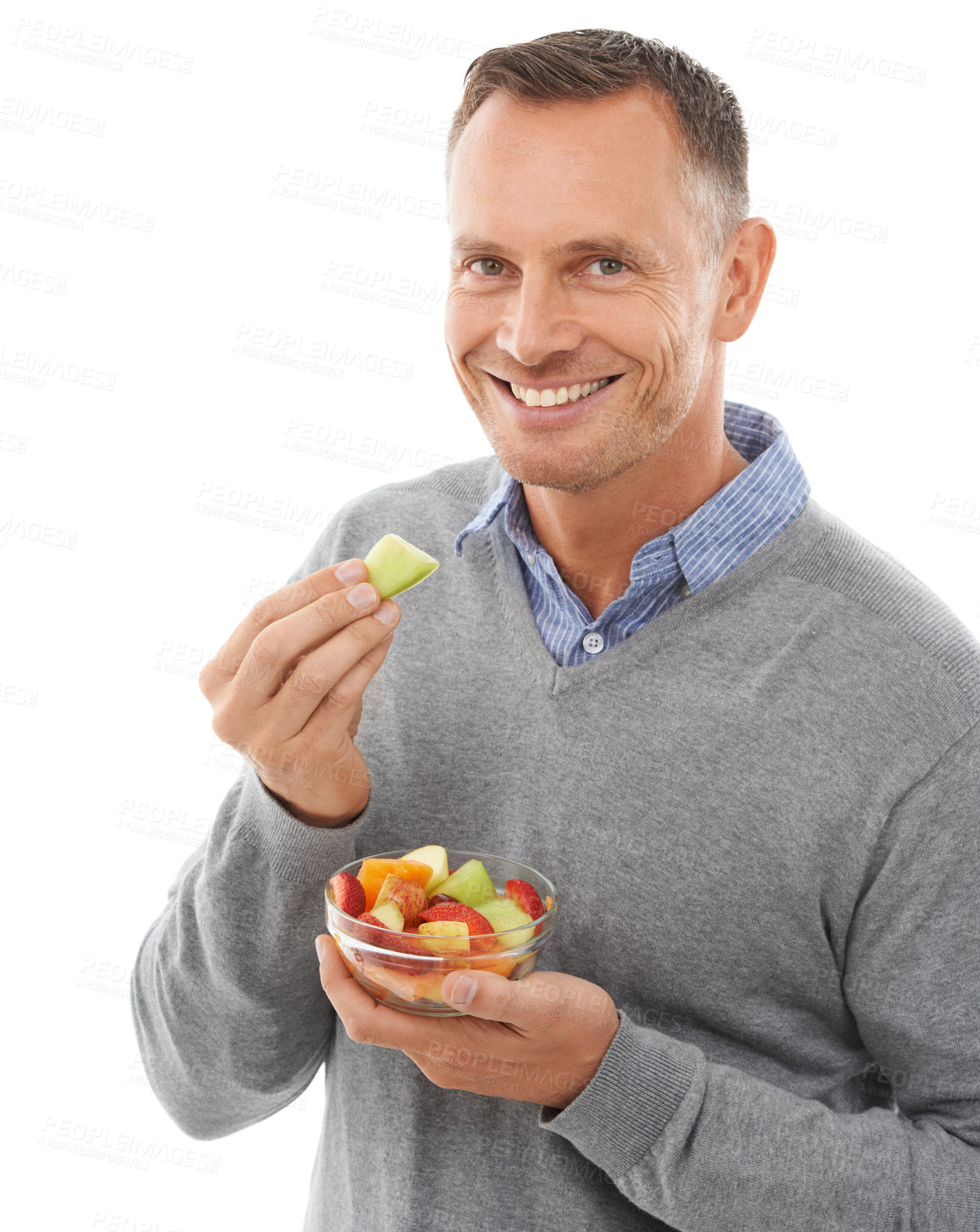 Buy stock photo Happy man with fruit salad isolated on a white background for healthy green lunch, diet choice or nutritionist breakfast. Professional vegan person or model eating fruits, food or apple in studio