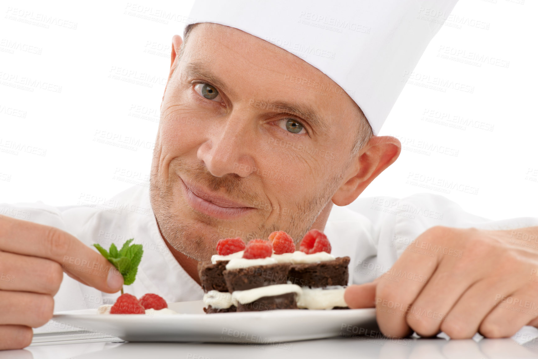 Buy stock photo Fruit, baking and portrait of a chef with cake presentation isolated on a white background in a studio. Smile, food and face of a professional baker with a sweet chocolate dessert for catering