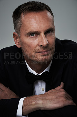 Buy stock photo Studio portrait of mature man, tuxedo and handsome, serious and isolated on grey background. Luxury, glamour and wealth, success with celebrity actor style, elegant and sexy date for valentines day.
