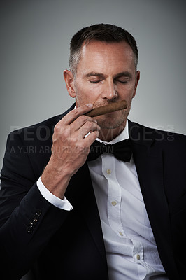 Buy stock photo Luxury, wealth and face of man with cigars for smoking habit on gray background for class, power and success. Mafia mockup, business gangster and isolated senior male smell tobacco for rich lifestyle