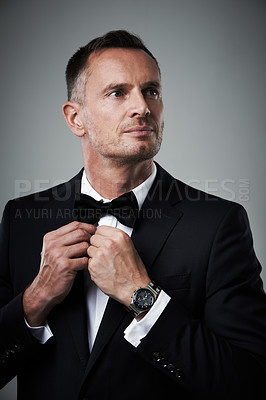 Buy stock photo Success, mature man in tuxedo with bow tie, handsome online dating profile picture isolated on grey background in studio. Luxury, rich elegant celebrity actor fashion and sexy date for valentines day