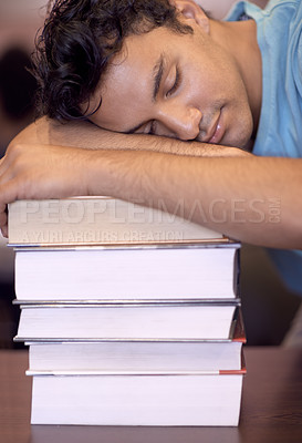 Buy stock photo Student man, sleeping and stack of books for education, development or exhausted with fatigue at college library. Person, learning and rest with burnout, tired or mental health for exam at university