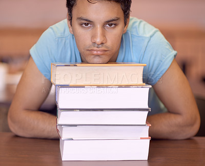Buy stock photo Student man, bored and stack of books for education, development or tired at college library. Person, learning or knowledge with anxiety, burnout or thinking for research with brain fog at university