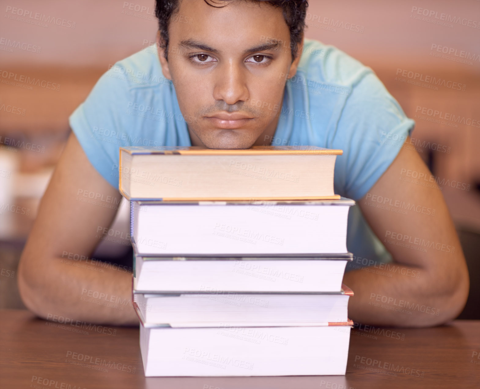 Buy stock photo Student man, bored and stack of books for education, development or tired at college library. Person, learning or knowledge with anxiety, burnout or thinking for research with brain fog at university