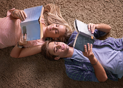 Buy stock photo Couple, reading and lying on floor for studying, scholarship or happy for development at university. Above man, woman or education in textbook for knowledge, information or research at college campus