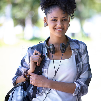 Buy stock photo A young woman with headphones around her neck
