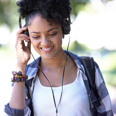 Buy stock photo Woman, headphones and music on university campus for entertainment, listening or education. Female person, smile and backpack at college for scholarship student or subscription, track or streaming