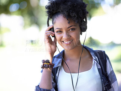 Buy stock photo Woman, portrait and headphones as student for music listening, entertainment or streaming. Female person, face and smile with backpack on study campus or outdoor fun for radio, relax or university
