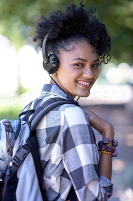 Buy stock photo Woman, portrait and headphones on campus for music listening, entertainment or streaming. Female person, student and smile with backpack for study learning or outdoor for radio, relax or university