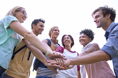 Buy stock photo Shot of a group of students putting their hands in a huddle