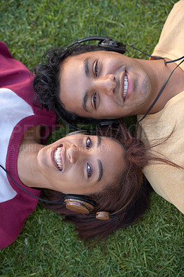 Buy stock photo Students, portrait and grass or headphones for music listening from above for entertainment, education or relax. Man, woman and friends or face on university campus or podcast, streaming or knowledge
