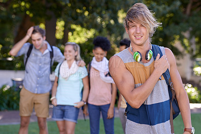 Buy stock photo Young man, headphones and portrait on campus and scholarship opportunity for happy at college. Student, smile and casual person with audio electronics, backpack and university outdoor for learning