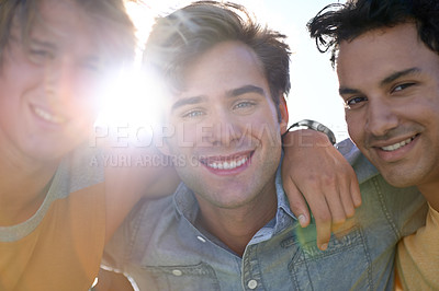 Buy stock photo Portrait of three young male friends standing outdoors