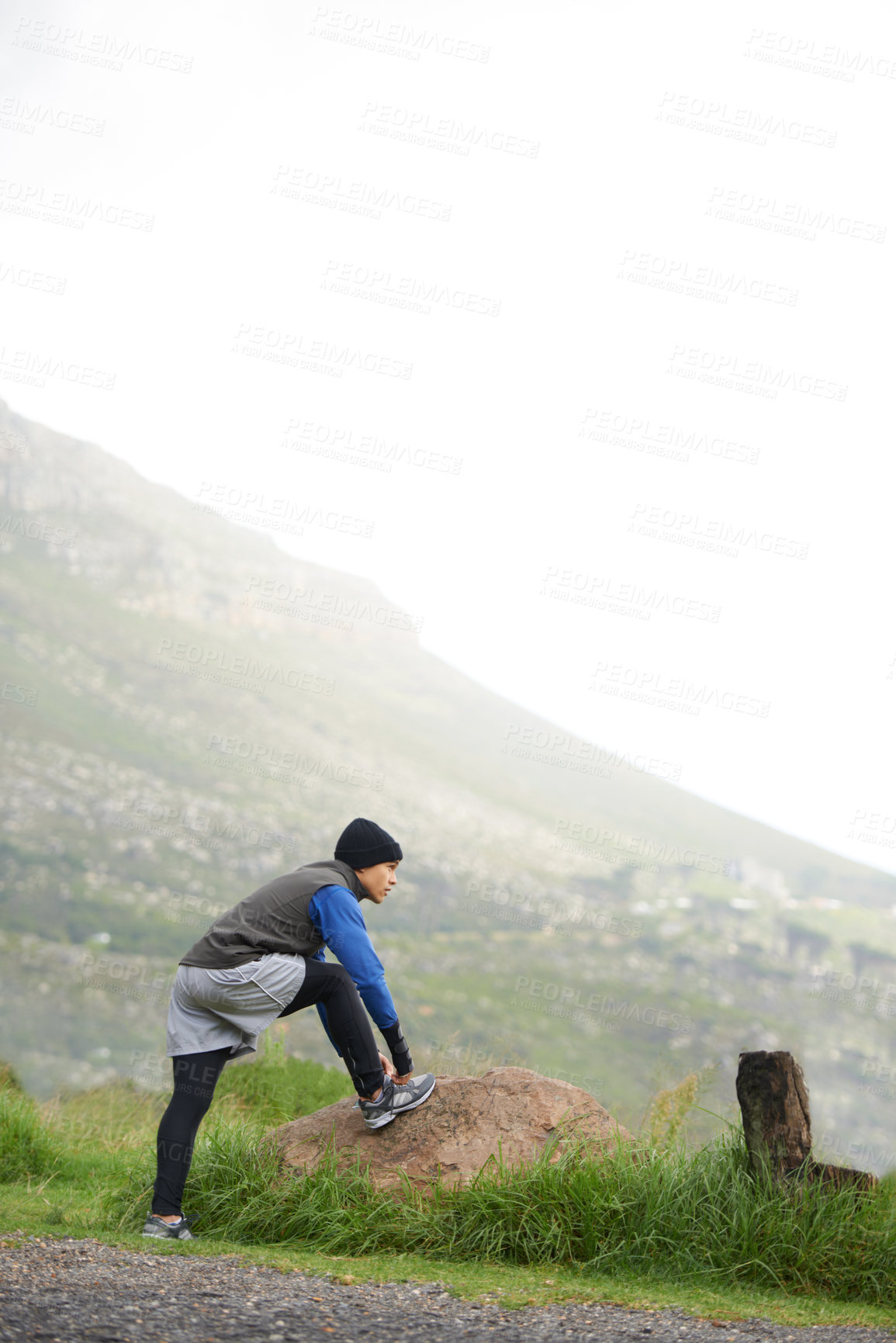 Buy stock photo Fitness, nature and a man stretching for a run, exercise or morning workout in the morning. Thinking, sports and a male runner or athlete with a warm up on the road for the start of training
