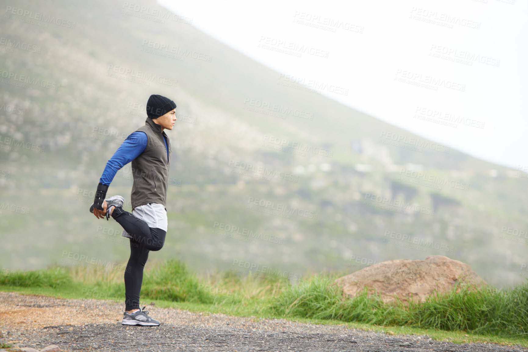 Buy stock photo Full length of a young jogger stretching in the morning and admiring the view