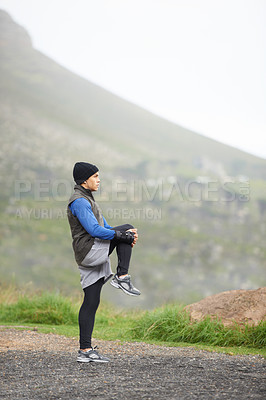 Buy stock photo Full length of a young jogger stretching in the morning and admiring the view