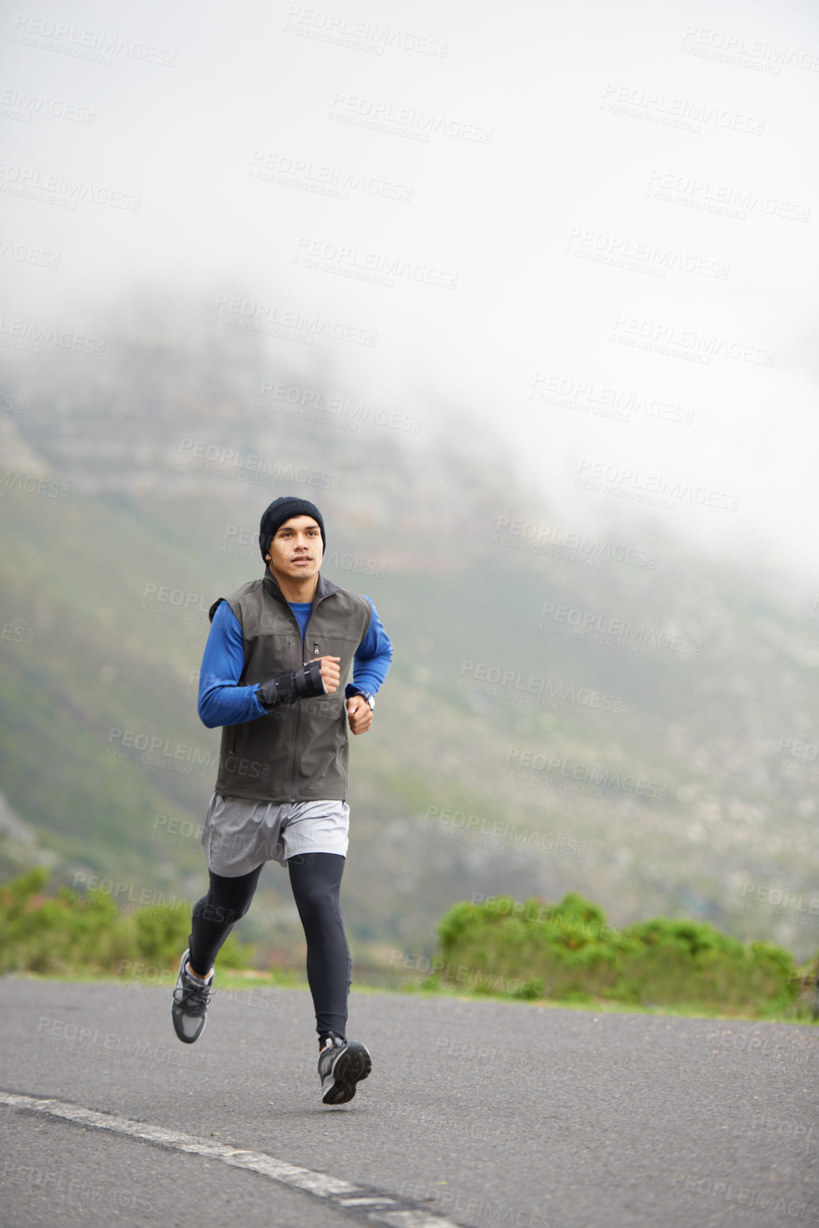 Buy stock photo Fitness, health and a man in the street for running, training and marathon competition. Winter, energy and a male runner or athlete in the road for sports, morning cardio or a workout in nature